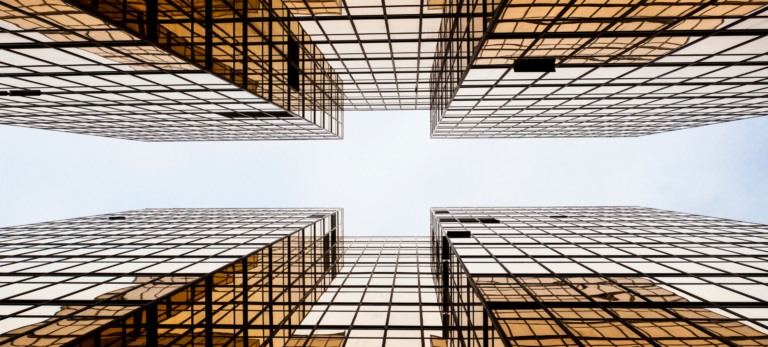 Two buildings with a glass exterior.